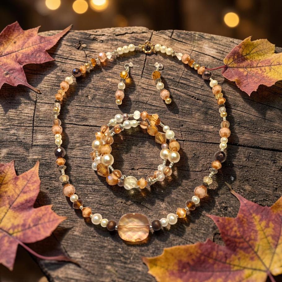 Autumn Amber Jewelry Set displayed on rustic wood with fall maple leaves and golden bokeh lights, featuring amber crystals, smoky quartz, and cream pearls