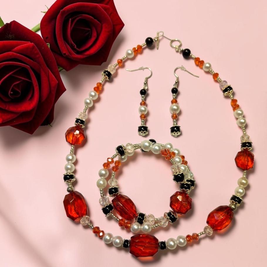 Red Rose Romance Jewelry Set with large faceted red crystal beads, white pearls, black onyx and carnelian chips, photographed with deep red roses