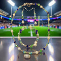Stadium Lights Jewelry Set with navy, green and teal crystals, gold beads, white pearls and rhinestone football charm, photographed at stadium