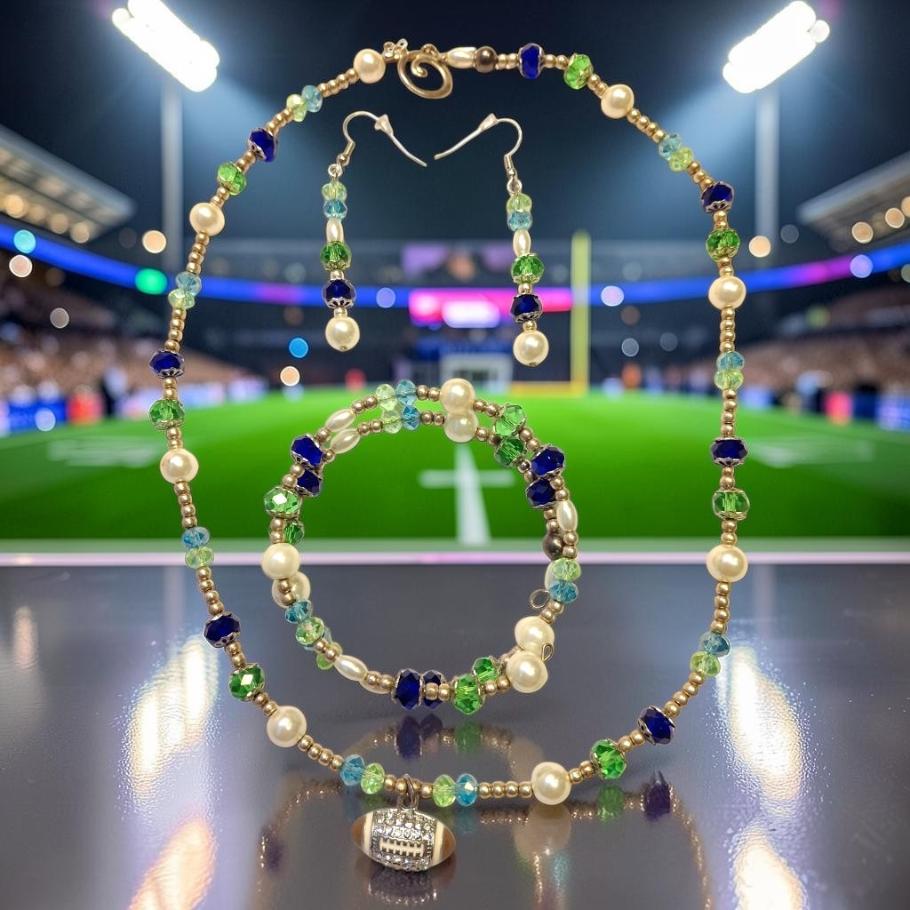 Stadium Lights Jewelry Set with navy, green and teal crystals, gold beads, white pearls and rhinestone football charm, photographed at stadium