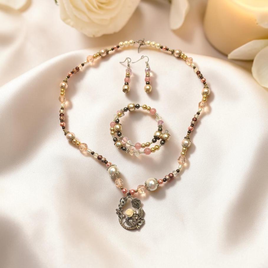 Antique Rose Garden Jewelry Set on ivory silk with white roses and candle, featuring antique silver rose butterfly pendant, rose quartz and champagne pearls