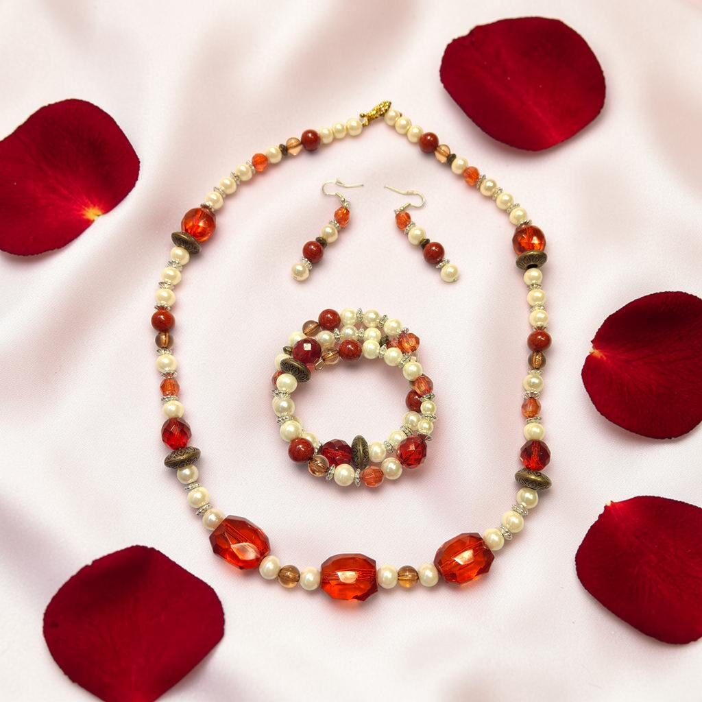 Touch of Romance beaded jewelry set with red crystals, cream pearls and bronze accents on white silk with rose petals