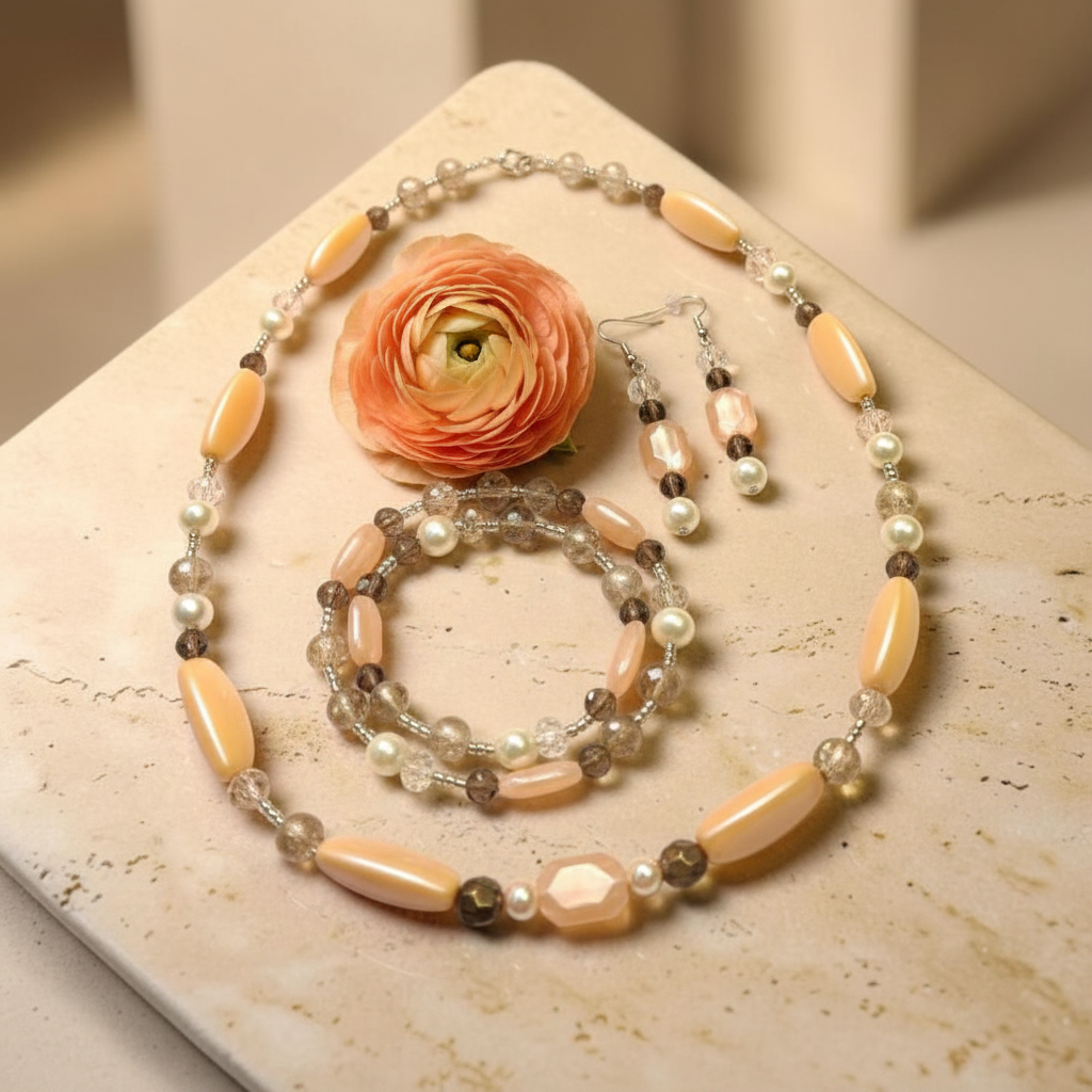 Blushing Dream Jewelry Set on travertine stone with peach ranunculus bloom